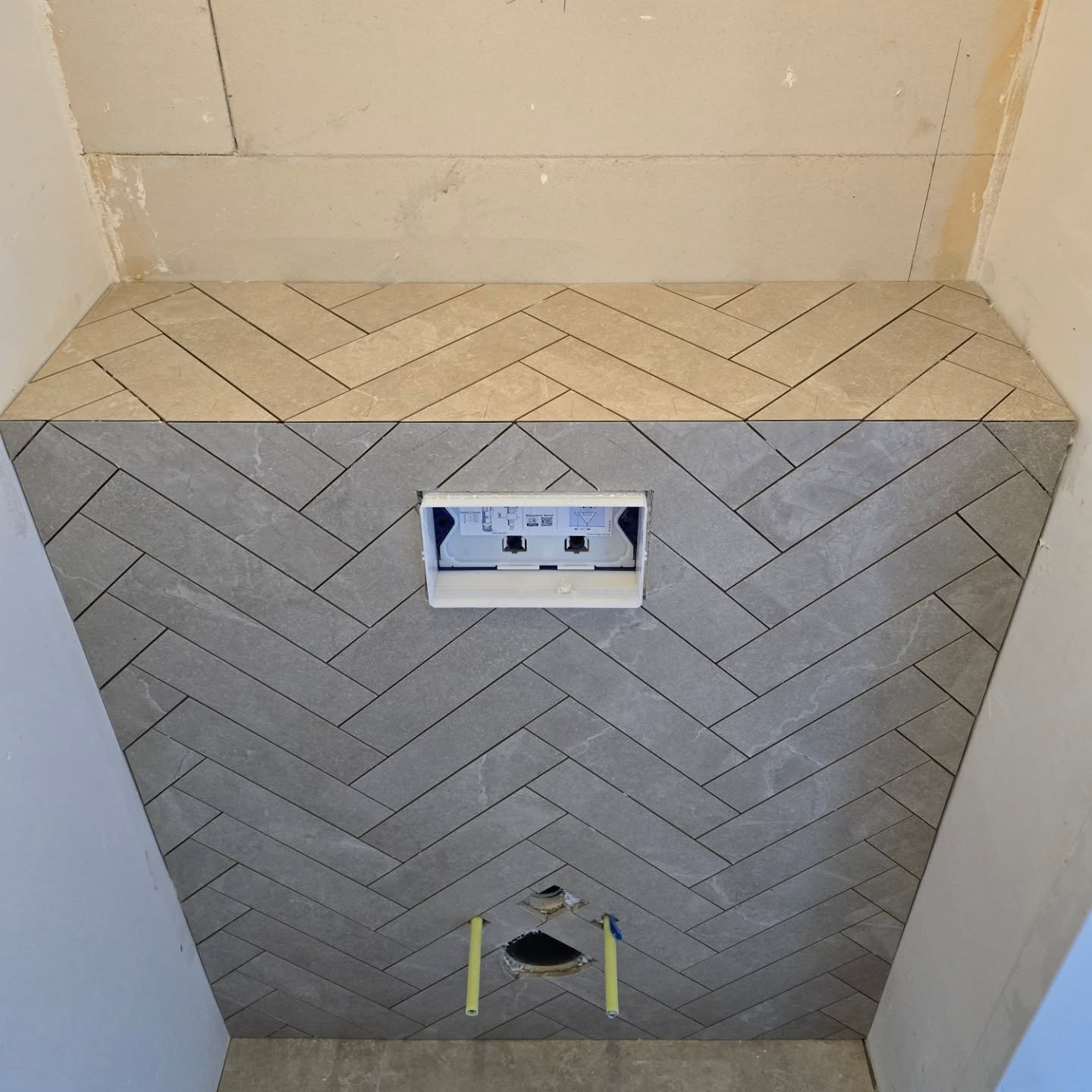 Work in progress showing a herringbone tile pattern folded around a mitred corner